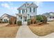 Charming two-story home with light blue siding and a welcoming front porch at 185 Stayman Park, Fayetteville, GA 30215