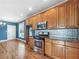 Stylish kitchen with stainless steel appliances, wood cabinets, and hardwood floors at 185 Stayman Park, Fayetteville, GA 30215