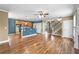 Open-concept living area features hardwood floors, recessed lighting, and a kitchen with blue cabinets and a breakfast bar at 185 Stayman Park, Fayetteville, GA 30215