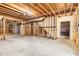 Unfinished basement showcasing exposed ceiling beams, concrete floors, and a framed area ready for customization at 2358 Alexander Farms Sw Ct, Marietta, GA 30064