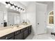 Bright bathroom with double sinks, a large mirror, ample counter space, and a separate tub area at 2358 Alexander Farms Sw Ct, Marietta, GA 30064
