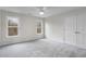 Bright bedroom featuring neutral carpet, white walls, double windows and closet doors at 2358 Alexander Farms Sw Ct, Marietta, GA 30064