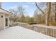 A spacious deck with white railings, overlooking a private backyard and green landscape, perfect for outdoor relaxation at 2358 Alexander Farms Sw Ct, Marietta, GA 30064