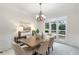 Bright dining room with modern chandelier, large window, and seating for six at 2358 Alexander Farms Sw Ct, Marietta, GA 30064
