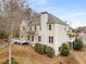 View of the back of a two-story home with large windows, a deck, and landscaped grounds at 2358 Alexander Farms Sw Ct, Marietta, GA 30064