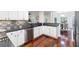 Stylish kitchen with black countertops, stainless steel appliances, and white cabinets is perfect for cooking at 2358 Alexander Farms Sw Ct, Marietta, GA 30064