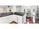 Open kitchen design with stainless steel appliances and black countertops flows into living spaces at 2358 Alexander Farms Sw Ct, Marietta, GA 30064