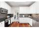 Contemporary kitchen features stainless steel appliances, black countertops, and white cabinets at 2358 Alexander Farms Sw Ct, Marietta, GA 30064