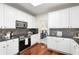 Updated kitchen featuring stainless steel appliances, modern cabinetry, and black countertops at 2358 Alexander Farms Sw Ct, Marietta, GA 30064