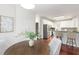 Bright eat-in kitchen features hardwood floors, white cabinets, granite countertops, and stainless steel appliances at 2358 Alexander Farms Sw Ct, Marietta, GA 30064