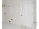 Efficient laundry area features clean white walls, tiled floor, and convenient shelving for storage at 2358 Alexander Farms Sw Ct, Marietta, GA 30064