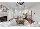 Cozy living room with fireplace, ceiling fan, and wood floors is perfect for relaxing and entertaining guests at 2358 Alexander Farms Sw Ct, Marietta, GA 30064