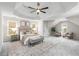 Spacious main bedroom with tray ceiling, natural light, a seating area, and soft carpet for comfort at 2358 Alexander Farms Sw Ct, Marietta, GA 30064