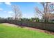 The yard of a house that features a wood fence at 2463 Turnbury Glen Walk, Snellville, GA 30078
