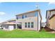 The exterior of a house that includes a covered patio and well-kept lawn at 2463 Turnbury Glen Walk, Snellville, GA 30078