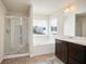 Bright bathroom with a glass shower, soaking tub, and wood vanity at 2463 Turnbury Glen Walk, Snellville, GA 30078