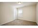 Neutral bedroom featuring plush carpet, bright natural light from a window, and a white interior door at 2463 Turnbury Glen Walk, Snellville, GA 30078