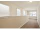 A well-lit upstairs hallway features neutral walls, carpet, and bright windows at the end of the hall at 2463 Turnbury Glen Walk, Snellville, GA 30078