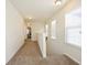 Upstairs hallway with neutral walls and carpet and a view to a staircase at 2463 Turnbury Glen Walk, Snellville, GA 30078