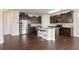 Open concept kitchen includes stainless appliances, granite counters, and an island with seating, perfect for modern living and entertaining at 2463 Turnbury Glen Walk, Snellville, GA 30078