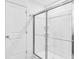 Bathroom shower with chrome frame, sliding doors and tiled floors at 3639 Olive Grove Ln, Covington, GA 30016