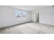 Bright bedroom with plush carpet, two windows, and access to the ensuite bathroom at 3639 Olive Grove Ln, Covington, GA 30016