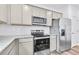 Updated kitchen featuring granite countertops, stainless steel appliances, and subway tile backsplash at 3639 Olive Grove Ln, Covington, GA 30016