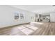 Bright, open-concept living room with wood floors connecting to the kitchen, perfect for entertaining at 3639 Olive Grove Ln, Covington, GA 30016