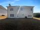 Backyard view of a two story home with a lawn at 4028 Elm Trace Dr, Loganville, GA 30052