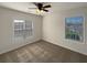 Sunny bedroom with neutral colored walls, carpet, and two windows providing natural light at 4028 Elm Trace Dr, Loganville, GA 30052