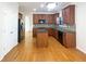 Well-lit kitchen boasts an island, modern appliances, and beautiful wood floors at 4028 Elm Trace Dr, Loganville, GA 30052