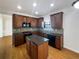 Kitchen featuring cherry wood cabinets, granite countertops, and stainless appliances at 4028 Elm Trace Dr, Loganville, GA 30052