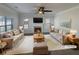 Staged living room featuring a fireplace, neutral color palette, and plush rug at 4028 Elm Trace Dr, Loganville, GA 30052