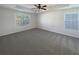 Spacious main bedroom features neutral colored walls, carpet, and a ceiling fan at 4028 Elm Trace Dr, Loganville, GA 30052