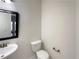 Clean powder room featuring a sink, toilet, and modern fixture at 4028 Elm Trace Dr, Loganville, GA 30052