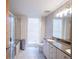 Modern bathroom featuring a shower, granite countertop, tile floors, and plenty of light at 1133 Church Se St # 2, Covington, GA 30014