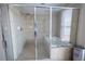 Modern bathroom features tiled shower with glass door, soaking tub by window at 1133 Church Se St # 2, Covington, GA 30014
