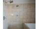 Neutral-toned tiled shower with dual shower heads and tub at 1133 Church Se St # 2, Covington, GA 30014