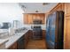 Functional kitchen featuring stainless steel appliances, gas range and dark wood cabinets at 1133 Church Se St # 2, Covington, GA 30014