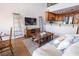 Cozy living room featuring open kitchen with modern appliances and comfortable white sofa at 1133 Church Se St # 2, Covington, GA 30014