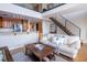 Inviting living room features stairs, loft and open kitchen with stainless steel appliances and breakfast bar at 1133 Church Se St # 2, Covington, GA 30014