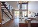 Bright living room with open staircase, balcony access, dining area, and kitchen bar at 1133 Church Se St # 2, Covington, GA 30014