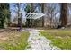 Landscaped backyard features a pergola, a stone pathway, and lush green grass at 1802 S Gordon Sw St, Atlanta, GA 30310