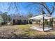 Backyard with pergola, gravel, stone path, grass, and the back of the house at 1802 S Gordon Sw St, Atlanta, GA 30310