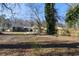 Large backyard features a pergola and a mix of lush green grass and bare areas at 1802 S Gordon Sw St, Atlanta, GA 30310