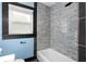 Modern bathroom with a tiled shower, new fixtures, and natural light from the window at 1802 S Gordon Sw St, Atlanta, GA 30310
