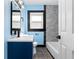 Well-lit bathroom showcasing a blue vanity, tiled shower, and contemporary fixtures at 1802 S Gordon Sw St, Atlanta, GA 30310