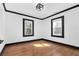 Bright bedroom with hardwood floors, white walls, and contrasting black trim around the windows at 1802 S Gordon Sw St, Atlanta, GA 30310