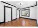 Bedroom featuring hardwood floors, white walls, black trim, closet, and natural lighting at 1802 S Gordon Sw St, Atlanta, GA 30310
