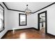 Dining room features hardwood floors, black trim, modern light fixture, and an open entrance to the kitchen at 1802 S Gordon Sw St, Atlanta, GA 30310